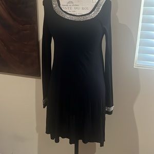 Black with silver embellishment on necklace and end of sleeves.